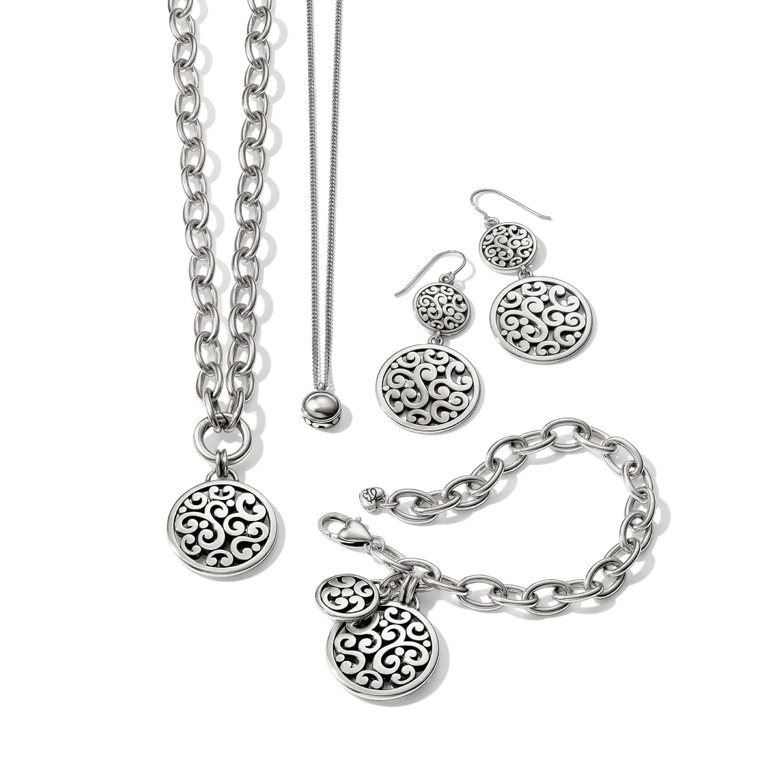 Brighton silver-plated jewelry set styled with matching pendant necklaces, drop earrings, and chain bracelet with scrollwork medallions