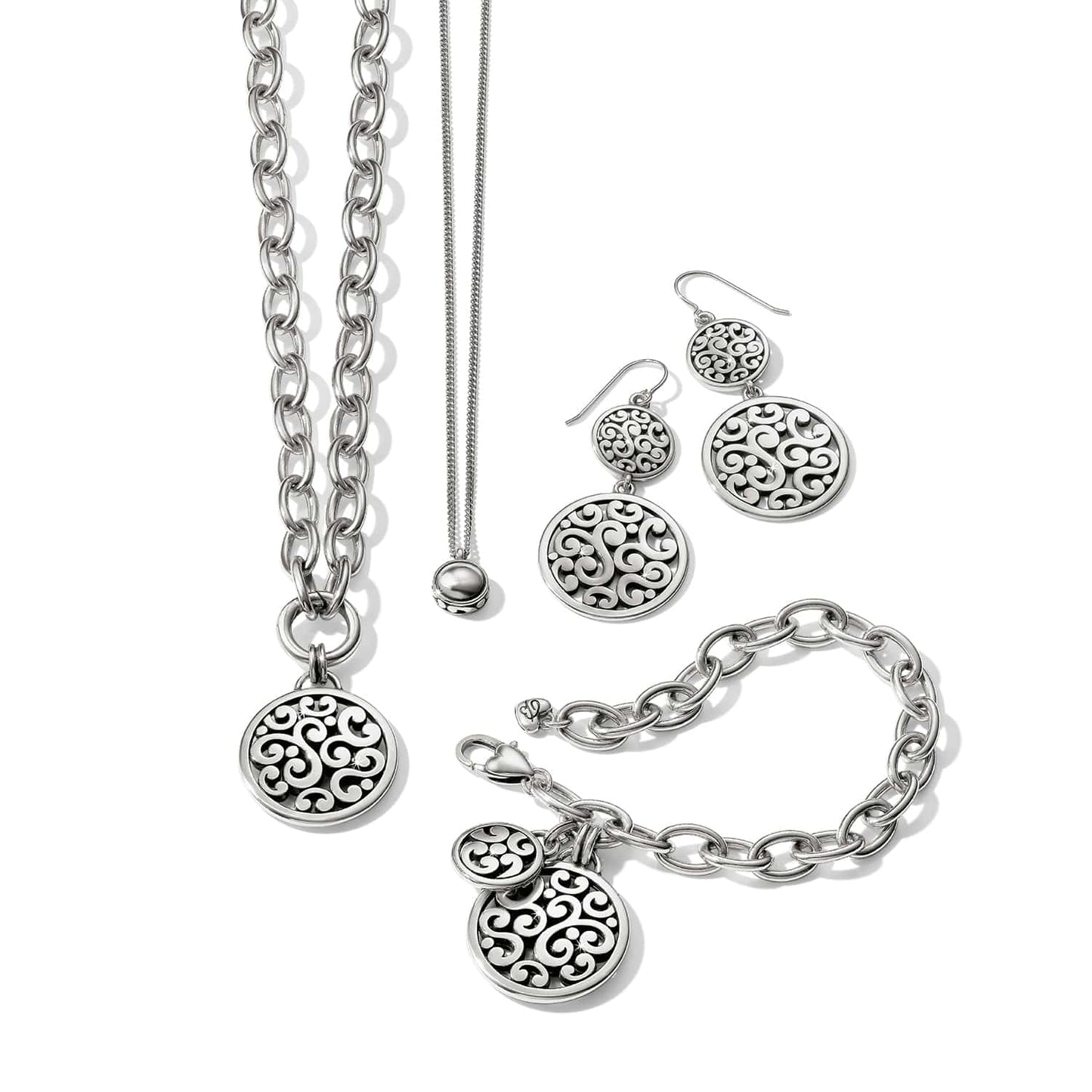 Brighton silver-plated jewelry set styled with matching pendant necklaces, drop earrings, and chain bracelet with scrollwork medallions