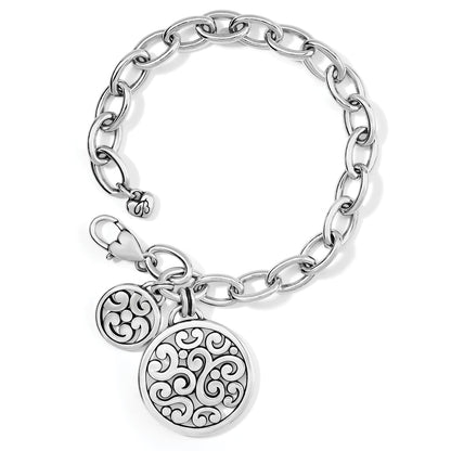 Brighton charm bracelet with silver-tone link chain and two round filigree scrollwork medallion charms on a white background