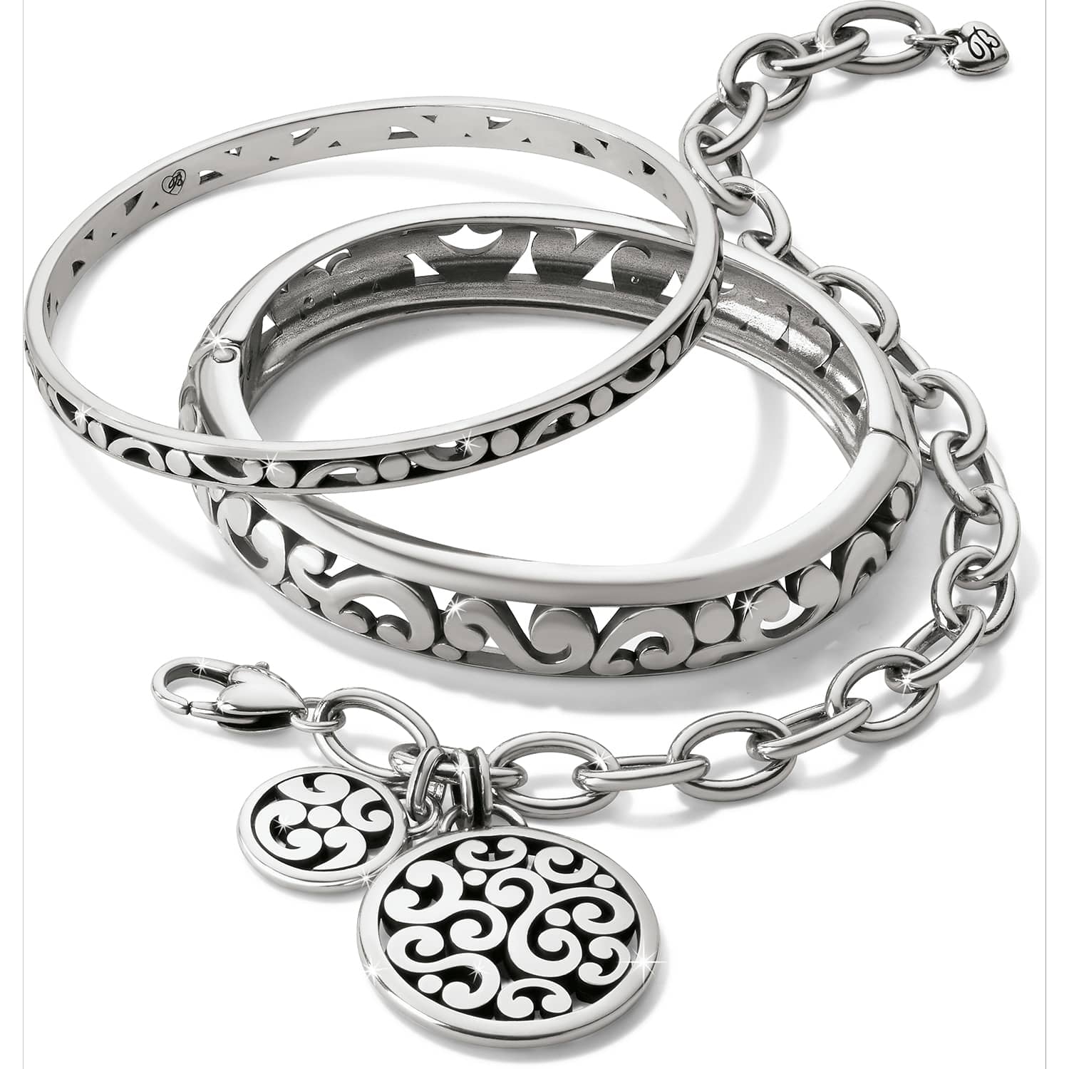 Brighton bangle bracelets and charm bracelet set with silver-tone scroll cutout designs and round medallion charms on a white background