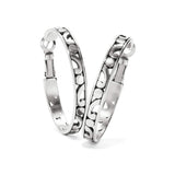 Brighton hoop earrings with silver-plated openwork scroll design and hinged closures on a white background