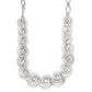 Brighton silver-plated necklace with linked swirl motifs and small bead accents on a white background