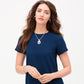 Model wearing a Brighton silver-plated pendant necklace with openwork teardrop design and coordinating Brighton accessories