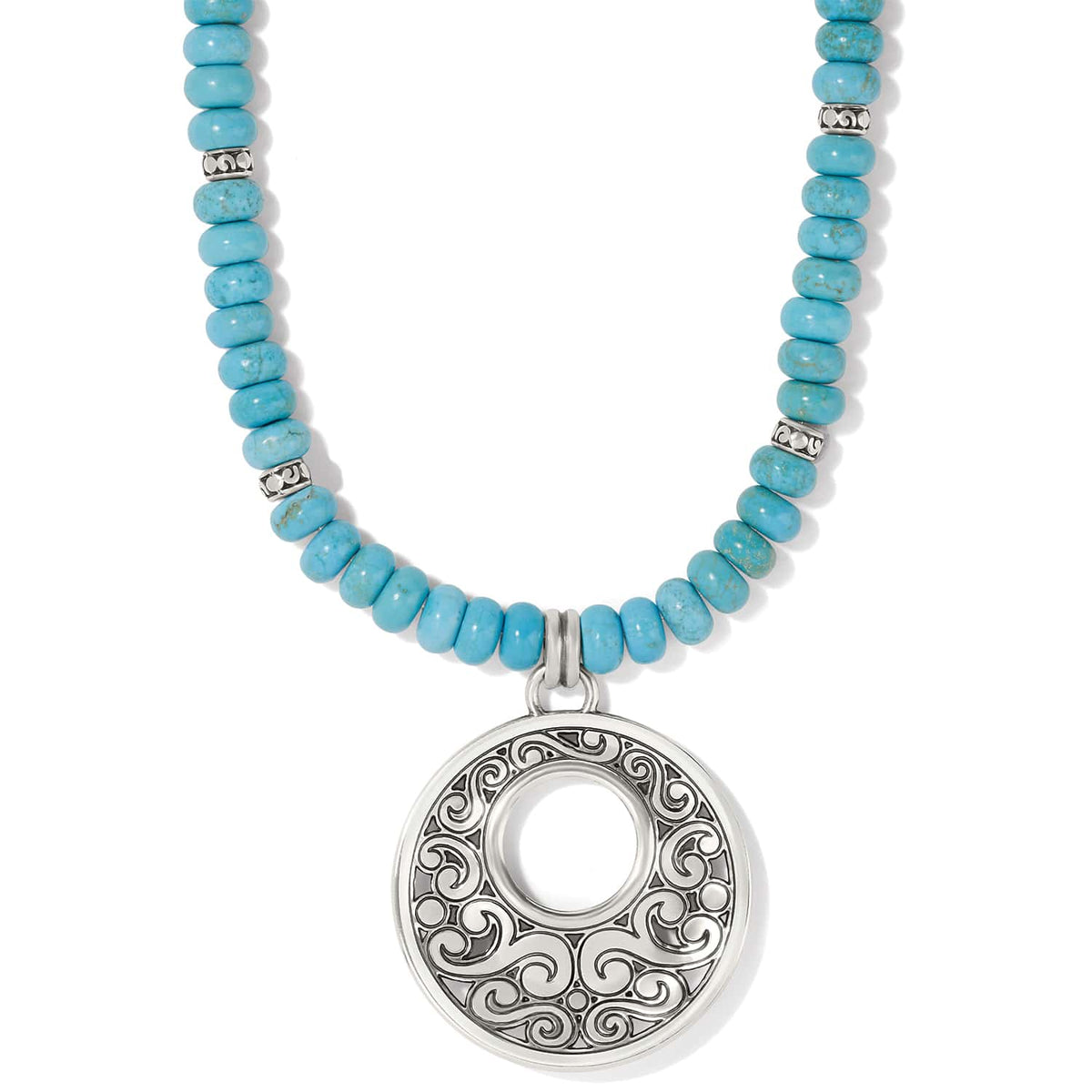 Brighton pendant necklace with dyed howlite turquoise beads and silver-plated openwork scroll medallion on a white background