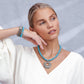 Model wearing a Brighton pendant necklace with dyed howlite beads and silver-plated openwork medallion, with coordinating Brighton accessories
