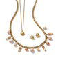 Brighton gold-plated layered necklace and stud earrings set with peach and cream marbled beads on a white background