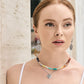 Model wearing Brighton silver-plated scroll drop earrings and layered beaded necklace with silver-plated heart pendant
