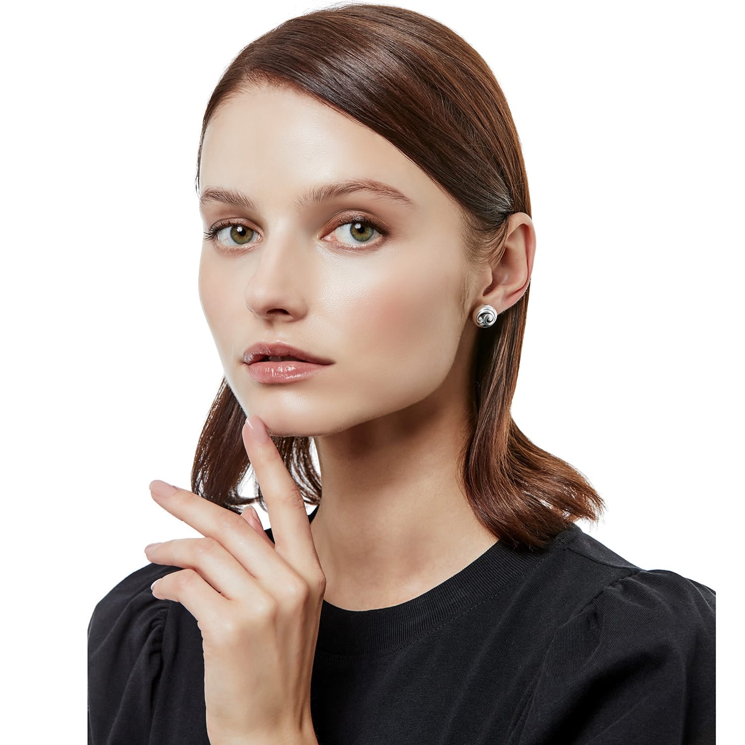 Model wearing a Brighton silver-plated stud earring with swirled dome design and small crystal accent