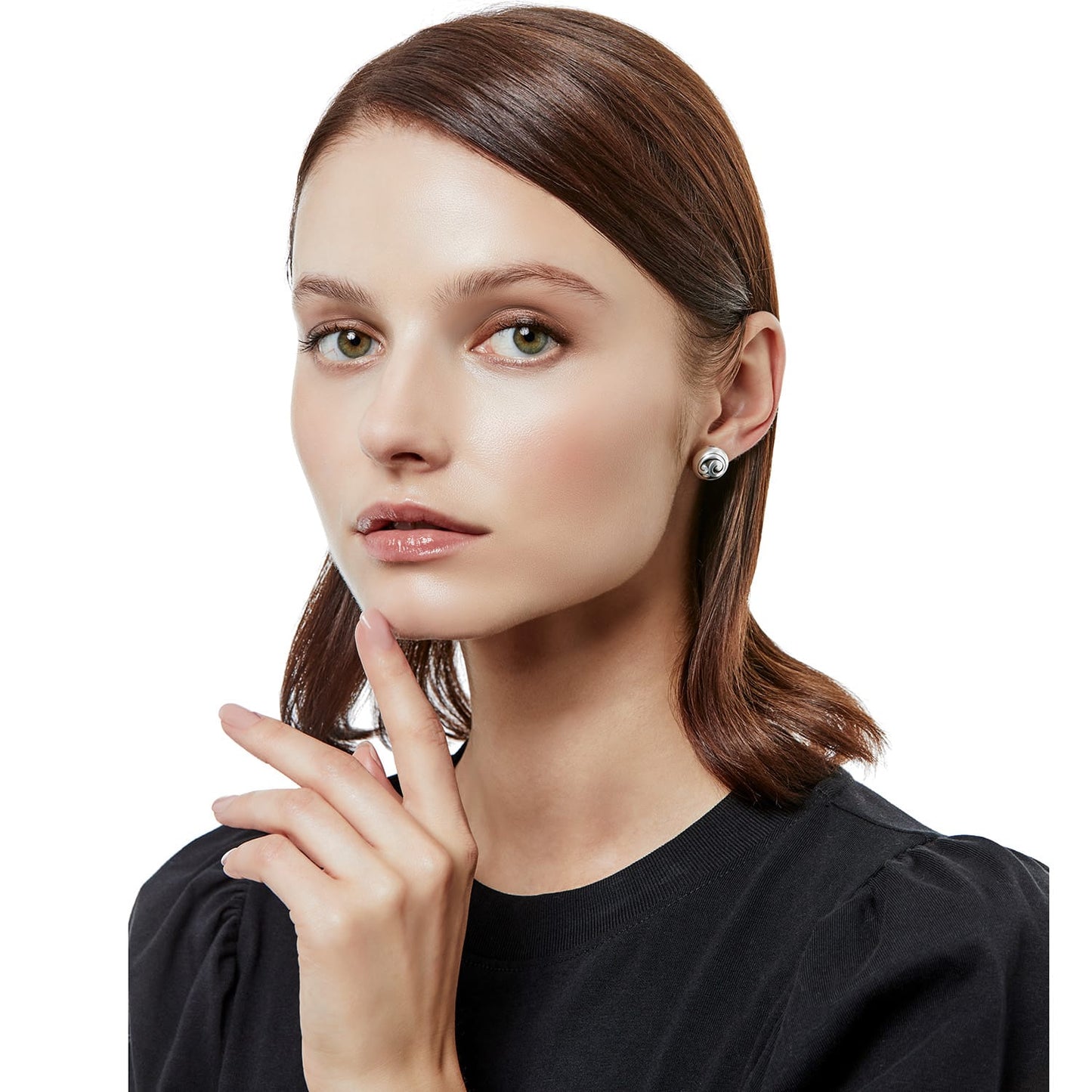 Model wearing a Brighton silver-plated stud earring with swirled dome design and small crystal accent