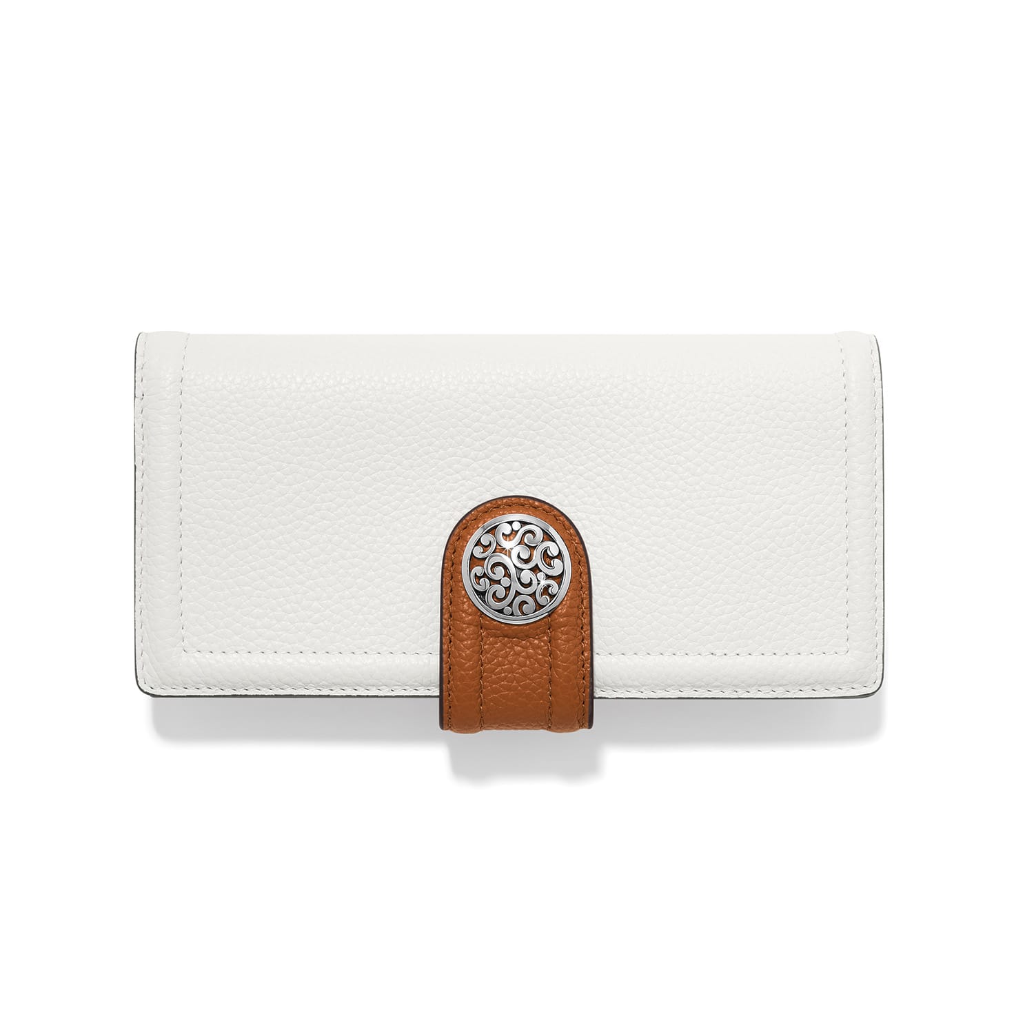 Brighton white leather wallet with brown tab closure and silver-tone scrollwork medallion on a white background