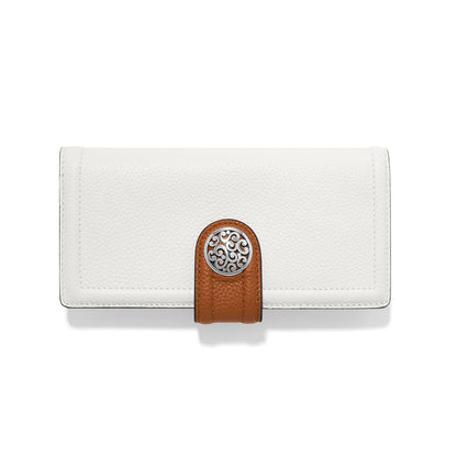 Brighton white leather wallet with brown tab closure and silver-tone scrollwork medallion on a white background