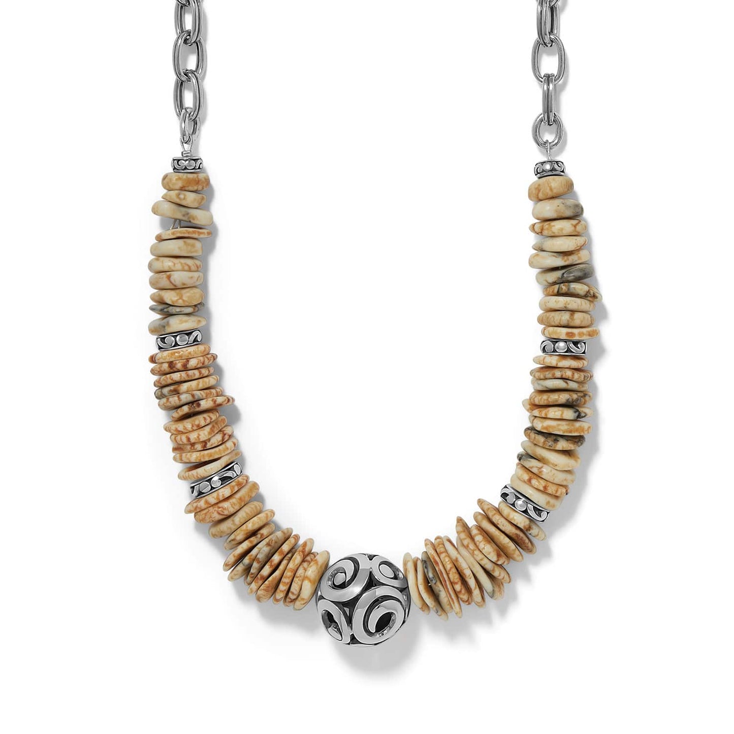 Brighton necklace with cream and tan disk beads, silver-plated ornate scroll bead, and chain on a white background