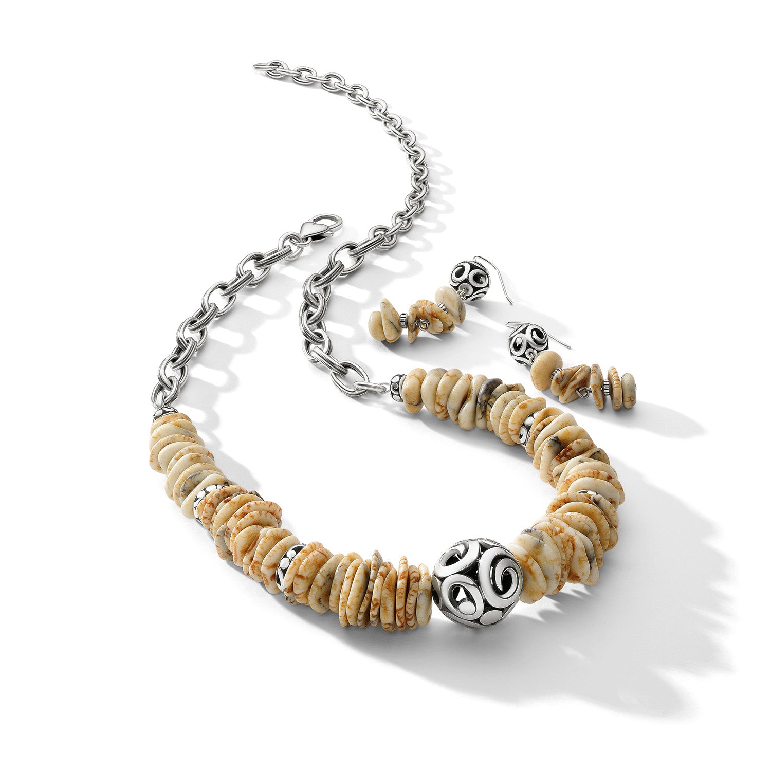 Brighton necklace and earrings set with cream disk beads and silver-plated ornate accents on a white background