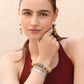 Model wearing Brighton drop earrings with disk beads and silver-plated ornate spheres, paired with coordinating Brighton accessories