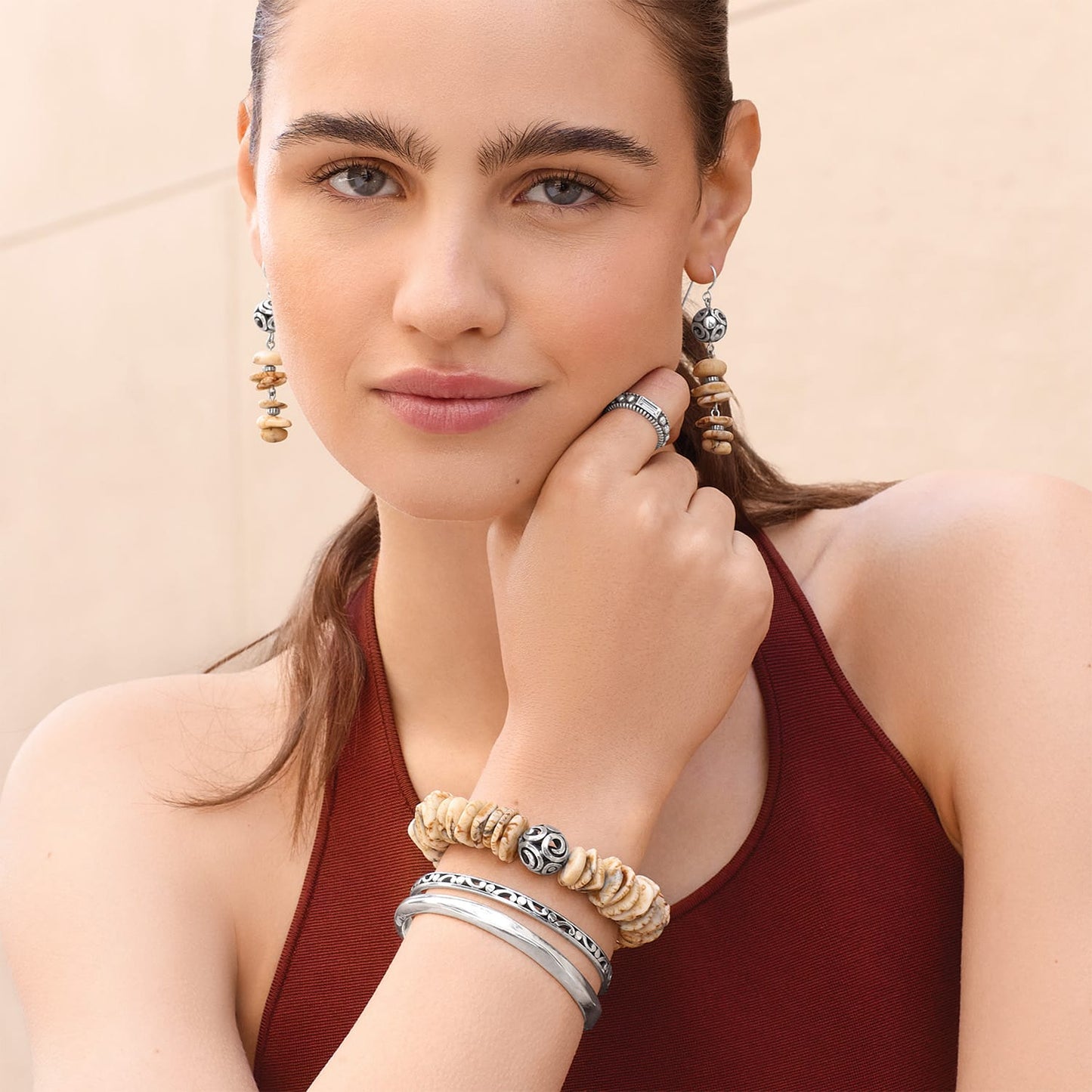Model wearing Brighton drop earrings with disk beads and silver-plated ornate spheres, with coordinating Brighton accessories