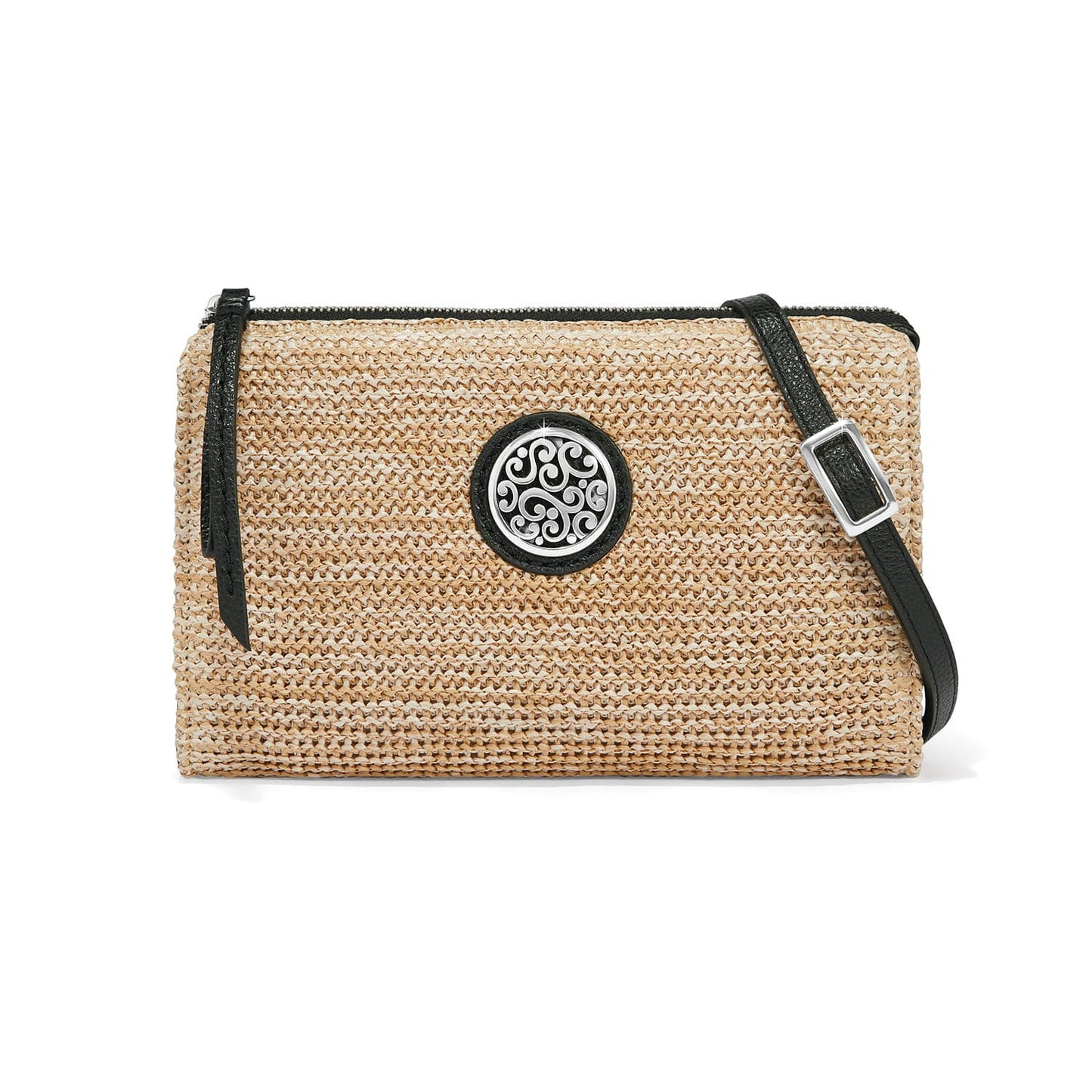 Brighton woven straw crossbody handbag with black leather trim, adjustable strap, and silver-tone scroll medallion on a white background