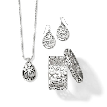Brighton jewelry set styled with silver-plated teardrop pendant necklace, matching earrings, and scrollwork bangle and cuff bracelets
