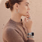 Model wearing Brighton silver-plated hoop earrings with coordinating Brighton accessories including a ring, watch, and bracelets.