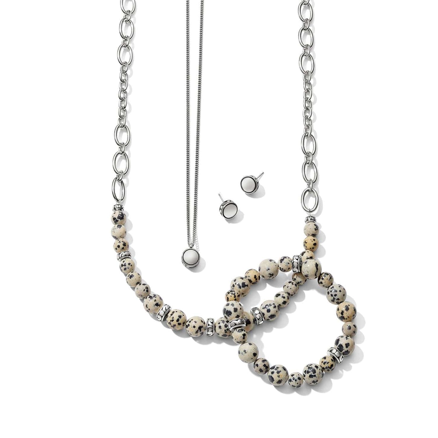 Brighton silver-plated jewelry set styled with Dalmatian jasper beaded bracelets and matching necklace and earrings on white