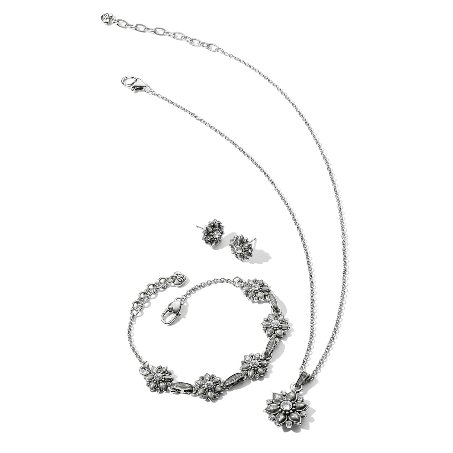 Brighton silver-plated floral jewelry set with necklace, bracelet, and stud earrings featuring crystal accents on white