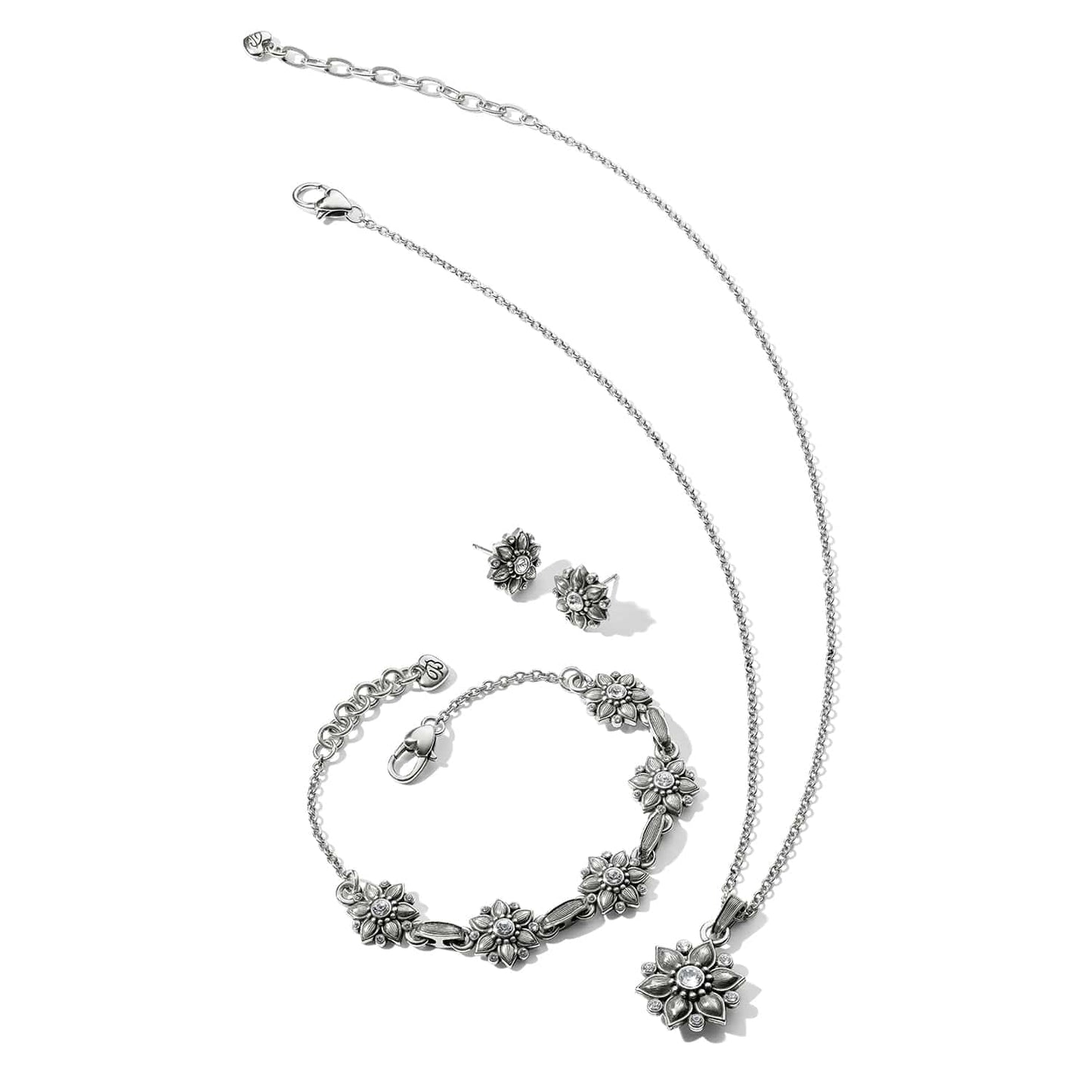 Brighton silver-plated floral jewelry set with necklace, bracelet, and stud earrings featuring crystal accents on white