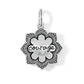 Brighton charm with silver-plated lotus flower design and engraved courage script in center on a white background