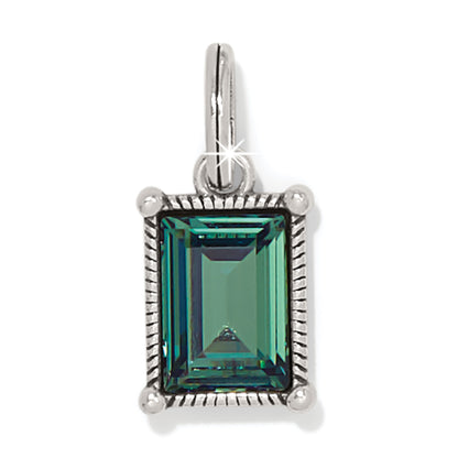 Brighton charm with emerald-cut green crystal in silver-plated rope-textured frame and bail on a white background