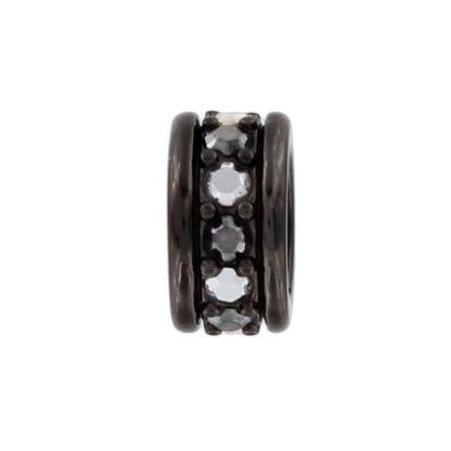 Brighton spacer charm with row of crystal stones set between dark metal banded edges on a white background