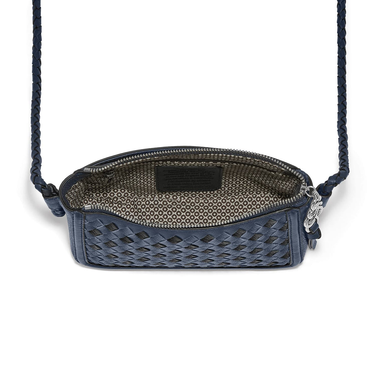 Brighton navy woven leather crossbody handbag shown open with patterned interior lining and braided strap on a white background