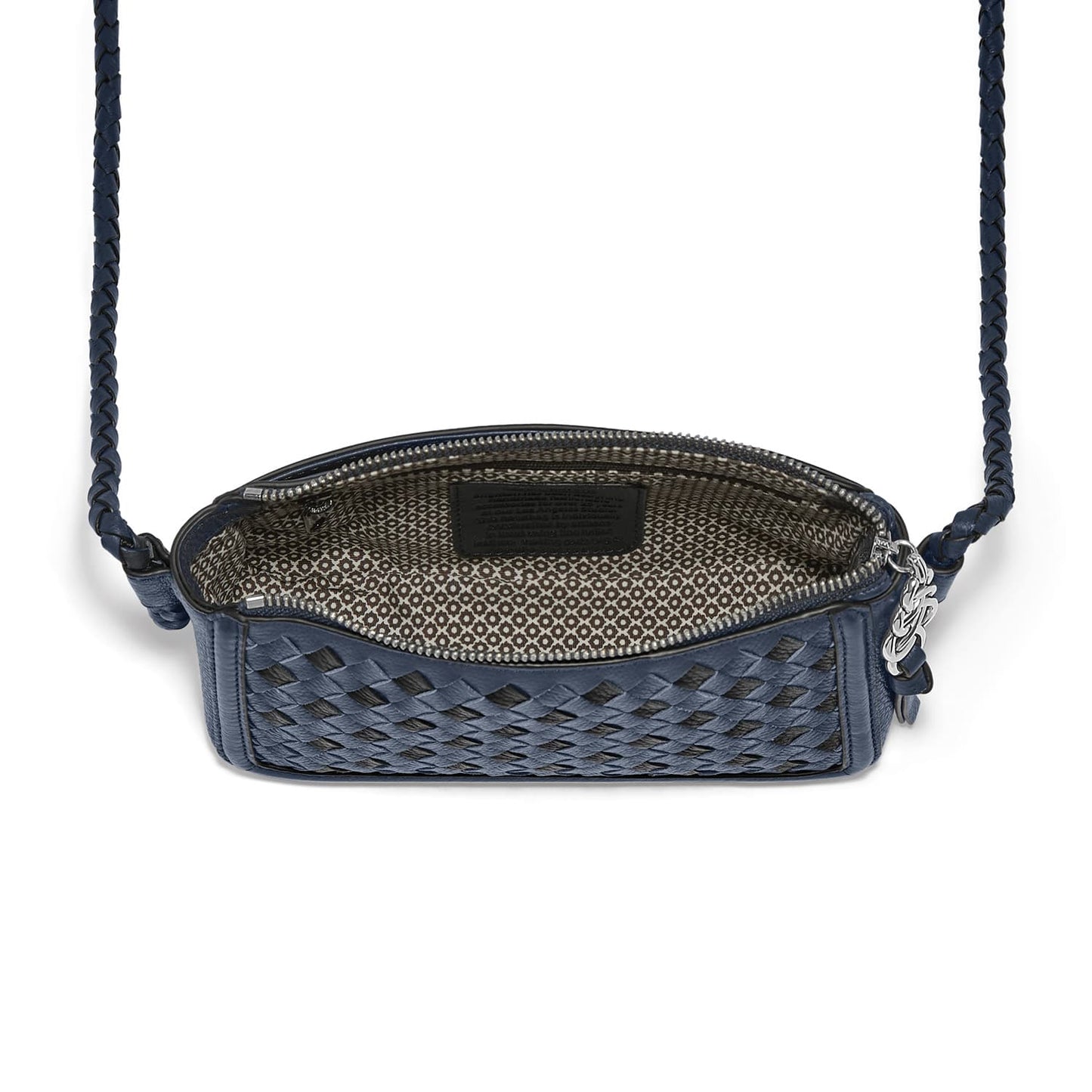 Brighton navy woven leather crossbody handbag shown open with patterned interior lining and braided strap on a white background