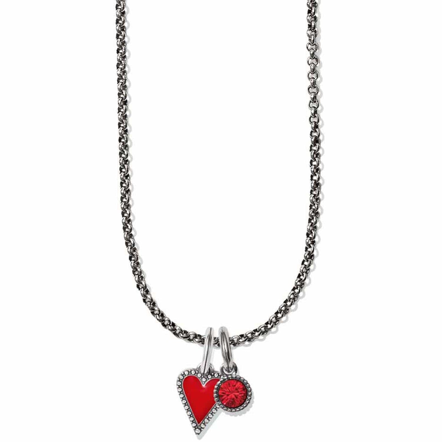 Brighton pendant necklace with silver-plated chain, red enamel heart charm, and red crystal charm on a white background
