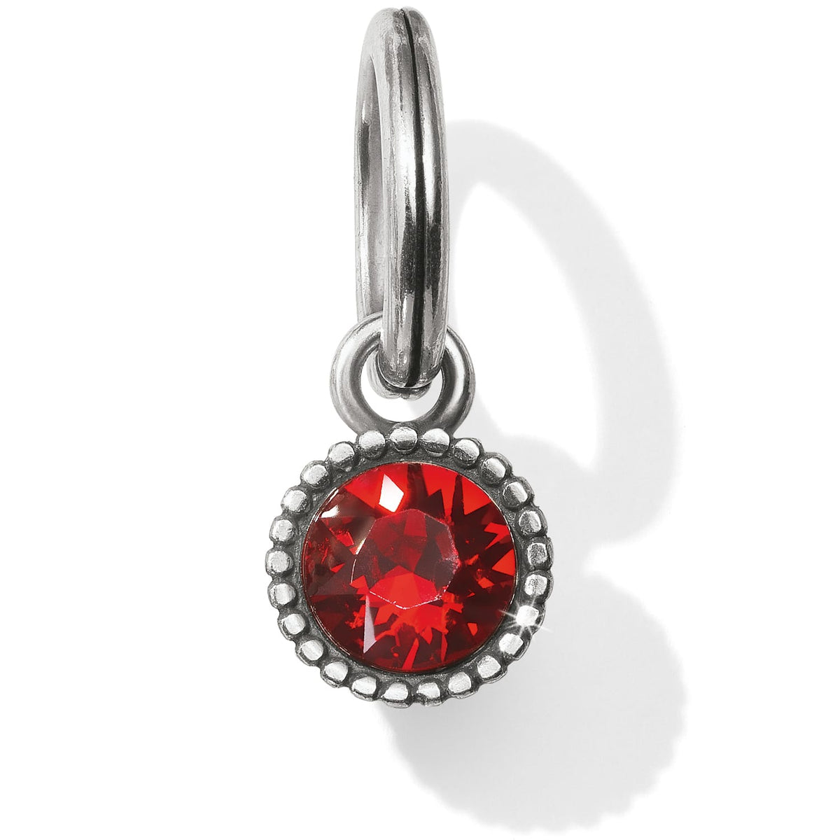 Brighton charm with round red crystal in beaded silver-plated bezel and split ring on a white background