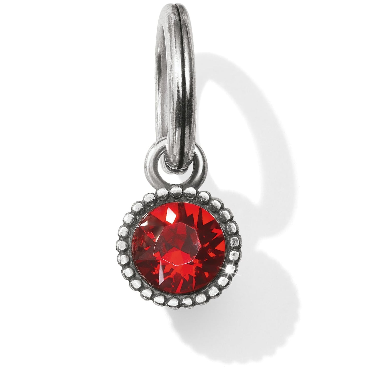 Brighton charm with round red crystal in beaded silver-plated bezel and split ring on a white background