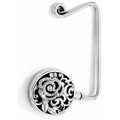 Brighton purse hook with ornate silver-tone floral medallion and crystal swirl accents on a white background