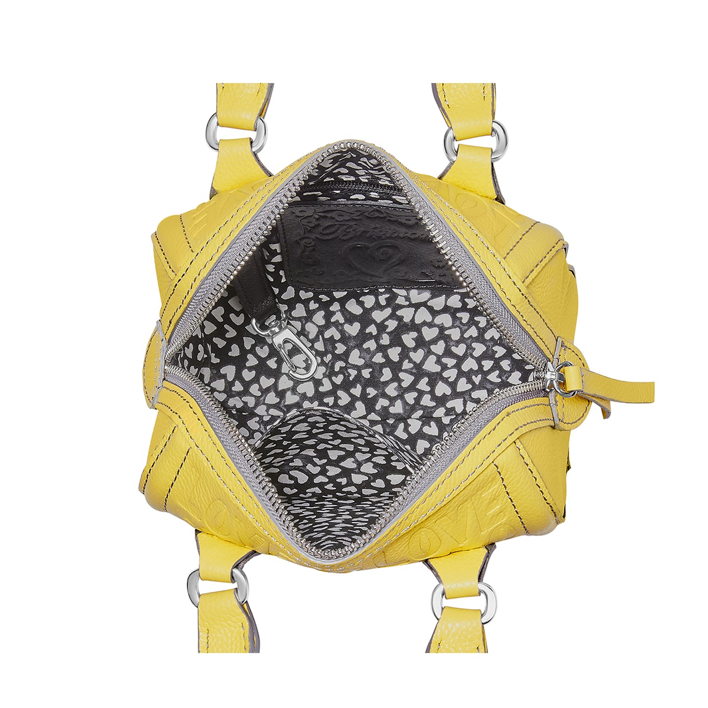Close-up of Brighton yellow leather handbag interior view with heart-print lining and silver-tone zipper on a white background