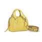 Brighton handbag in yellow leather with embossed love and heart motifs and woven logo strap on a white background