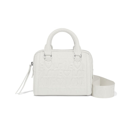 Brighton white handbag with embossed LOVE lettering, heart motifs, dual top handles, and detachable crossbody strap on a white background