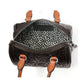 Close-up of Brighton handbag interior with heart-print lining, embossed leather exterior, and cognac leather handles