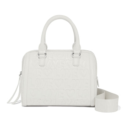 Brighton handbag in white with embossed love and heart pattern, dual handles, and detachable strap on a white background