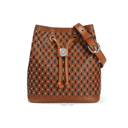 Brighton bucket handbag in tan leather with diamond cutouts, silver-tone studs, drawstring closure, and adjustable strap on a white background