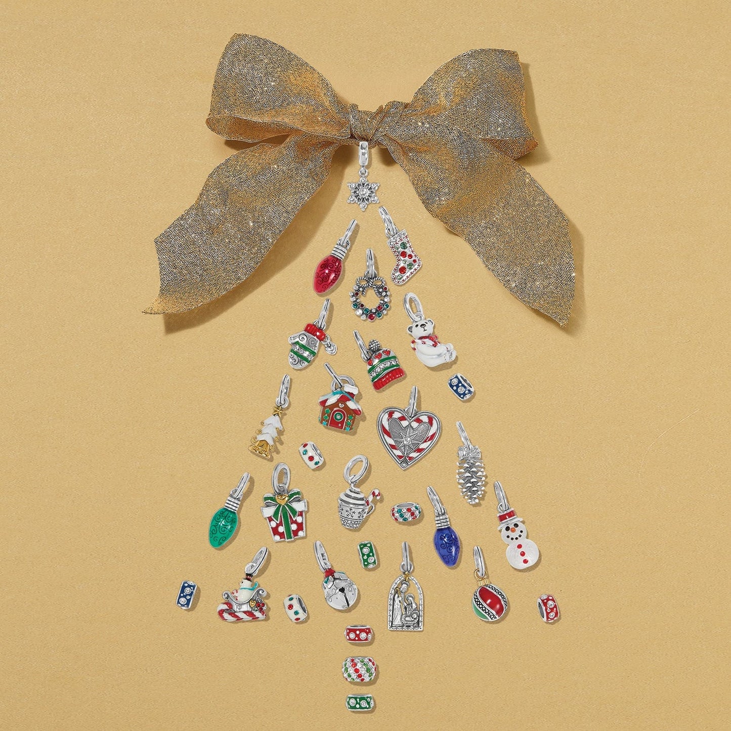 Brighton silver-plated charms styled with enamel and crystal accents arranged as a Christmas tree under a gold bow
