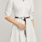 Model wearing a Brighton braided brown leather belt with ornate silver-tone oval buckle and hook closure