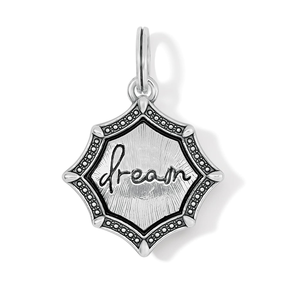 Brighton charm with silver-plated star-shaped medallion, engraved dream script, and beaded border on a white background
