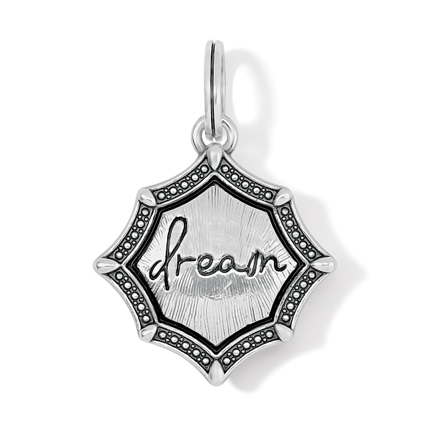 Brighton charm with silver-plated star-shaped medallion, engraved dream script, and beaded border on a white background