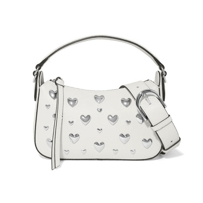 Brighton white handbag with silver-tone heart studs, top handle, and oversized buckle strap on a white background