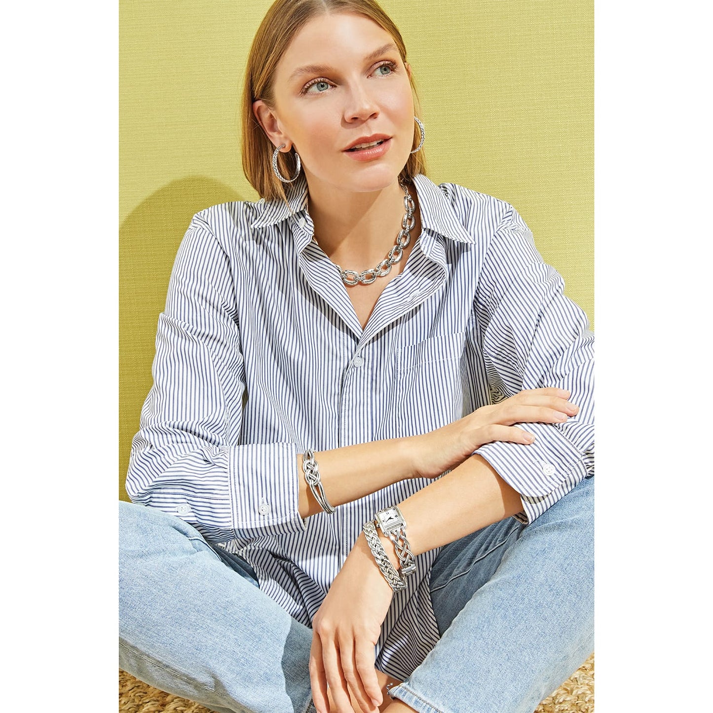 Model wearing a Brighton silver-plated chain link necklace with coordinating Brighton accessories including hoop earrings and bracelets