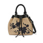Brighton handbag in tan with black floral embroidery, black leather handles, and drawstring closure on a white background