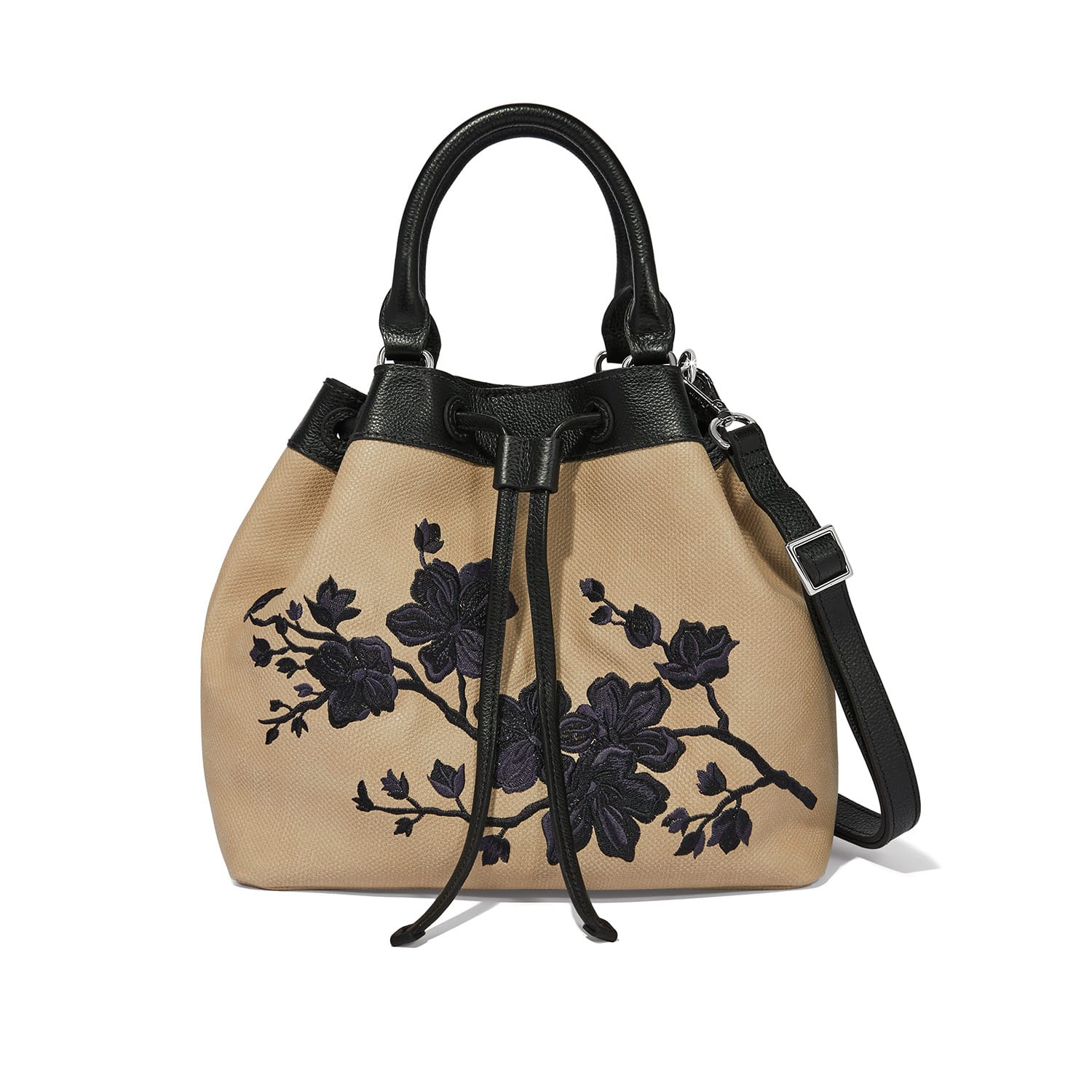 Brighton handbag in tan with black floral embroidery, black leather handles, and drawstring closure on a white background