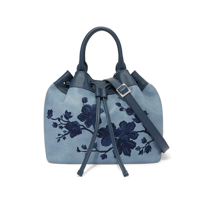 Brighton handbag in light blue with navy floral embroidery, leather handles, and drawstring closure on a white background