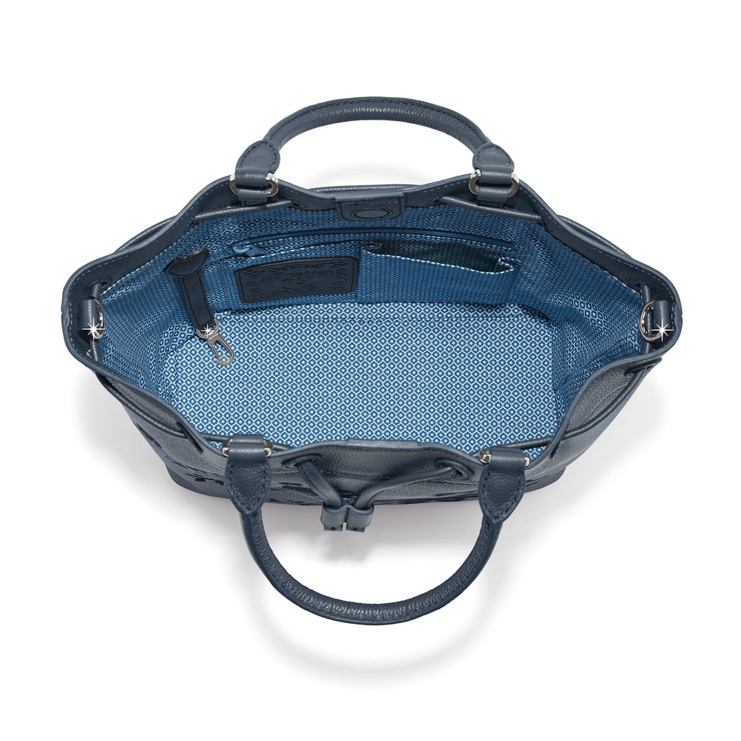 Brighton navy leather handbag interior view with patterned blue lining, zip pocket, and logo patch on a white background